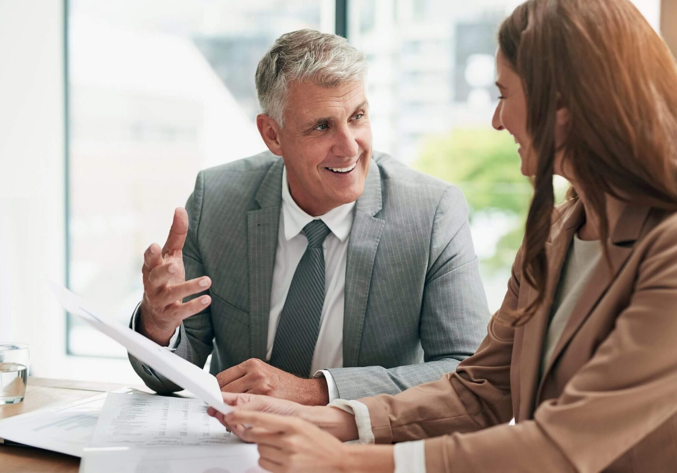 Man and woman discussing business documents.